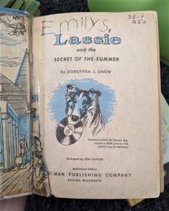 Title page of a Lassie book clearly showing a ripped preceding page, with childish handwriting spelling "Emily S." written it