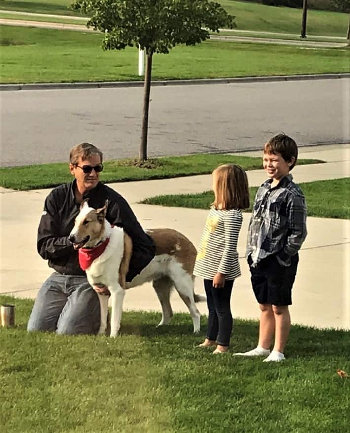 Tag stands outside with Wade, Parker, and Lucy