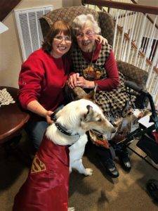 Tag is wearing a Superdog costume, posing with Veleda and Marie