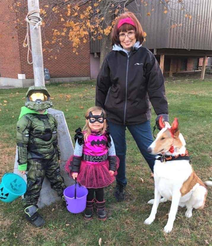 Veleda outside with Parker in a G.I. Joe costume, Lucy as a princess, and Tag wearing devil horns