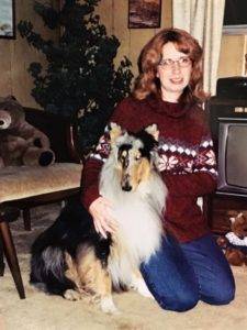 Veleda and Trinket seated indoors in front of an old TV.