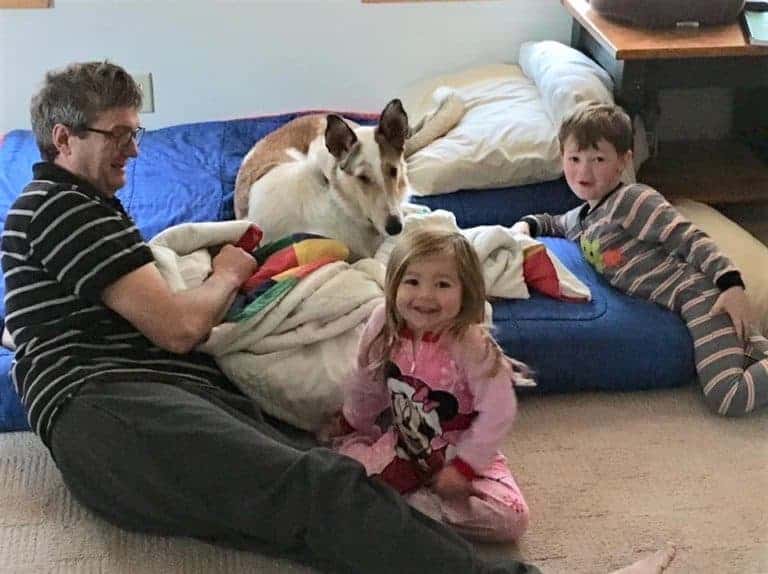 Wade, Parker, Lucy, and Tag lounging on a blowup floor bed