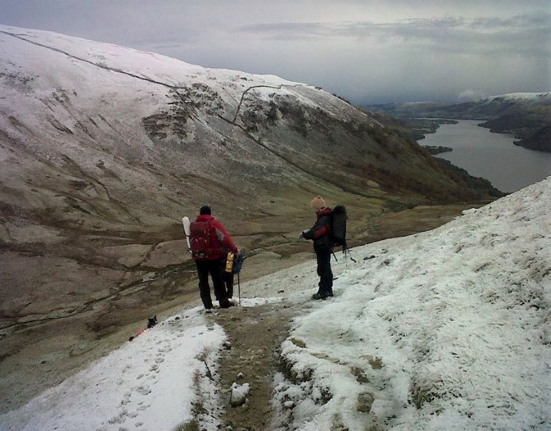 2 men with climbing gear on an icy mountainside