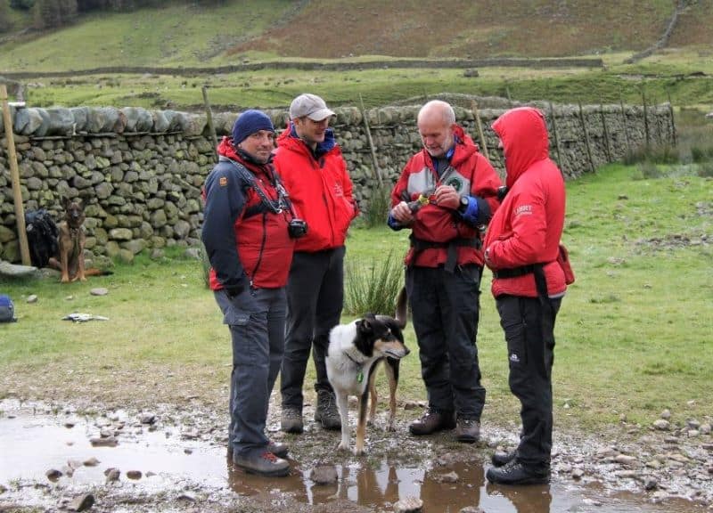 Finn stands amid a group of rescue team members