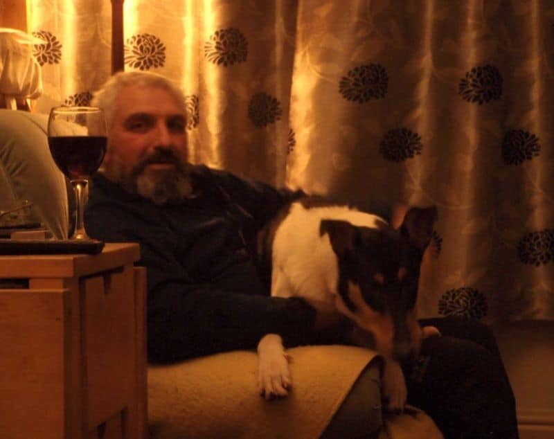 Rolf lying in Stephen's lap, big enough to hang over the side's of the armchair