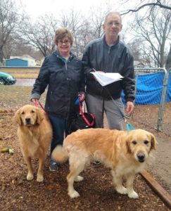 charlie and mary stand with Golden Retrievers Cory and Rascal