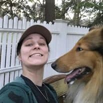 Selfie of a young girl and a sable and white Collie looking at her