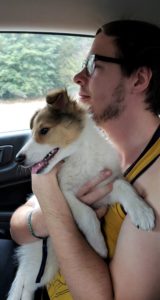 Dylan rides in a car with a happy little Vasya in his arms watching out the windows