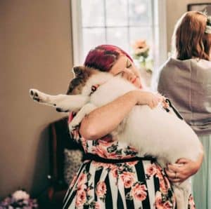 Vasya receives love and cuddles, held and hugged by one of Stephanie's bridesmaids