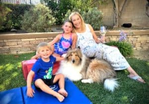 Cody lies outside with Donna and the grandkids, one young girl and one little boy